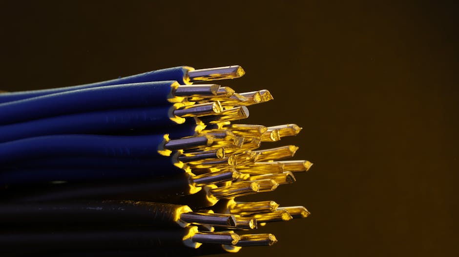 Detailed view of blue ethernet cables with exposed gold-plated conductors.